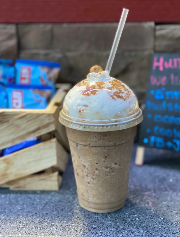 A blended frappe topped with whipped cream and cinnamon dust at Riverwoods Coffee